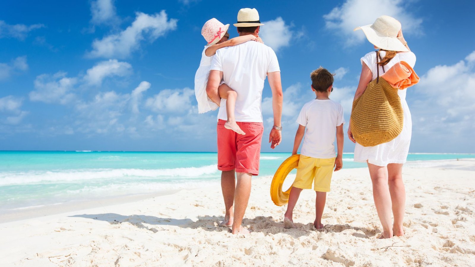 Family enjoying a beach day after moving to Florida